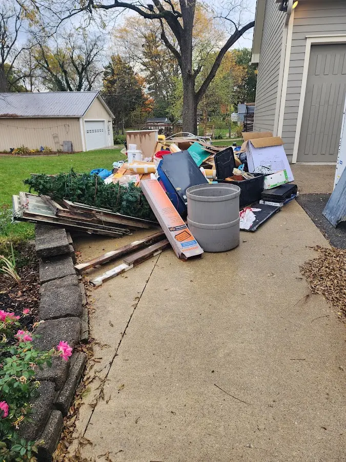 Dumpster being loaded with debris for 3 Yard Dumpster Rental in Helena-West Helena